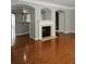Inviting living room featuring hardwood floors, a fireplace, and views of the kitchen at 6121 Joybrook Rd, Johns Creek, GA 30097