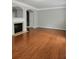 Open-concept living room with hardwood floors and a cozy fireplace at 6121 Joybrook Rd, Johns Creek, GA 30097
