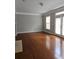 Bright living room featuring hardwood floors and access to the outdoors at 6121 Joybrook Rd, Johns Creek, GA 30097