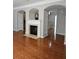 Bright and spacious living room features hardwood floors and a fireplace at 6121 Joybrook Rd, Johns Creek, GA 30097