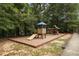 Community playground featuring a slide and play structures in a safe, landscaped area, ideal for Gathering fun at 6121 Joybrook Rd, Johns Creek, GA 30097