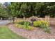 Landscaped brick entrance sign for Abbotts Bridge Place, offering a welcoming first impression to residents and visitors at 6121 Joybrook Rd, Johns Creek, GA 30097