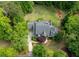 A landscaped yard and mature trees surrounds this home's well maintained roof and circular driveway at 1575 Spalding Dr, Sandy Springs, GA 30350