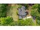 An aerial view displays lush green lawns, mature trees, and a neatly maintained asphalt roof at 1575 Spalding Dr, Sandy Springs, GA 30350