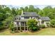 The rear exterior shows a screened porch, open porch, and a stone foundation at 1575 Spalding Dr, Sandy Springs, GA 30350