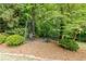 Charming backyard area featuring a shaded gazebo with seating, nestled among trees and greenery for a peaceful retreat at 1575 Spalding Dr, Sandy Springs, GA 30350