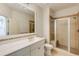 Bathroom featuring a glass shower and vanity with modern fixtures at 1575 Spalding Dr, Sandy Springs, GA 30350