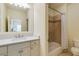 Well-lit bathroom with a white vanity, large mirror, and a bathtub with a shower at 1575 Spalding Dr, Sandy Springs, GA 30350