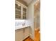 The butlers pantry features beautiful white cabinets and granite countertops at 1575 Spalding Dr, Sandy Springs, GA 30350