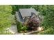A beautiful traditional home with stone and brick accents surrounded by mature trees and manicured landscaping at 1575 Spalding Dr, Sandy Springs, GA 30350
