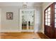 Elegant foyer featuring hardwood floors, decorative doors, and soft gray walls at 1575 Spalding Dr, Sandy Springs, GA 30350