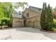 Spacious three car garage with brick facade and mature landscaping at 1575 Spalding Dr, Sandy Springs, GA 30350