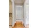 Hallway featuring white trim and doors, hardwood floors, and access to other rooms at 1575 Spalding Dr, Sandy Springs, GA 30350