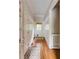 Hallway featuring hardwood floors, a decorative rug, and access to the exterior at 1575 Spalding Dr, Sandy Springs, GA 30350
