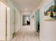 Hallway featuring hardwood floors, neutral paint and views into other rooms at 1575 Spalding Dr, Sandy Springs, GA 30350