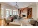 Living room with hardwood floors, fireplace, and view of the backyard through glass doors at 1575 Spalding Dr, Sandy Springs, GA 30350