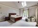 Airy main bedroom with tray ceiling, windows, neutral walls, and carpeted flooring at 1575 Spalding Dr, Sandy Springs, GA 30350