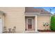 Inviting home featuring a front door with decorative ironwork and a charming seating area at 202 Accord Sw Ln, Grayson, GA 30017