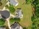 Aerial view of the property showcasing a large backyard, patio area, and surrounding greenery at 209 Braemar Ct, Mcdonough, GA 30253