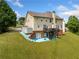 Spacious backyard with a deck, patio, and steps leading up to the home's back entrance at 209 Braemar Ct, Mcdonough, GA 30253
