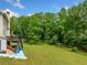 Lush backyard with mature trees and greenery at 209 Braemar Ct, Mcdonough, GA 30253