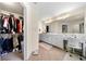 Bright bathroom with double sinks, shower, adjacent closet, and office area at 209 Braemar Ct, Mcdonough, GA 30253