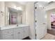 Bathroom has double doors, a wide mirror and a vanity with plenty of storage at 209 Braemar Ct, Mcdonough, GA 30253