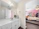 Bathroom includes a vanity with a large mirror, and an open doorway to bedroom at 209 Braemar Ct, Mcdonough, GA 30253