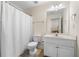 Bright bathroom features a white vanity, large mirror, and shower with white curtain at 209 Braemar Ct, Mcdonough, GA 30253