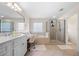 Bright bathroom boasts double sink vanity, soaking tub, separate shower, tile floors and great lighting at 209 Braemar Ct, Mcdonough, GA 30253