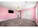 Bedroom featuring carpet, ceiling fan, TV, and a double door closet at 209 Braemar Ct, Mcdonough, GA 30253