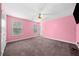 Pink bedroom features carpeting, ceiling fan, and natural light from two windows at 209 Braemar Ct, Mcdonough, GA 30253
