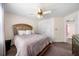 Cozy bedroom featuring a gold headboard, ceiling fan and a double closet with panel doors at 209 Braemar Ct, Mcdonough, GA 30253