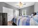 Cozy bedroom featuring twin beds with blue and white striped bedding, offering a comfortable and inviting space at 209 Braemar Ct, Mcdonough, GA 30253