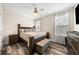 Cozy bedroom featuring a wood frame bed, wood floors, a ceiling fan, and two windows at 209 Braemar Ct, Mcdonough, GA 30253