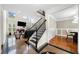 Grand two-story entryway featuring marble flooring, black staircase, and views into the living room and dining room at 209 Braemar Ct, Mcdonough, GA 30253