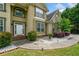 Inviting front entrance showcasing a white door, manicured bushes, and a concrete walkway with outdoor lighting at 209 Braemar Ct, Mcdonough, GA 30253