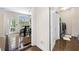 Hallway leading to laundry room, which has grey front load machines and a dining area at 209 Braemar Ct, Mcdonough, GA 30253