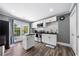 Modern kitchen features stainless appliances, island, tile backsplash, and backyard access at 209 Braemar Ct, Mcdonough, GA 30253