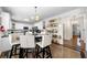 Eat-in kitchen with white cabinets, open shelving, stainless steel appliances and a view into a hallway at 209 Braemar Ct, Mcdonough, GA 30253