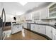 Bright kitchen with white cabinets, stainless steel appliances, a center island and an eat-in table at 209 Braemar Ct, Mcdonough, GA 30253