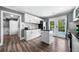 Bright kitchen with white cabinets, black countertops, stainless steel appliances, and access to the backyard at 209 Braemar Ct, Mcdonough, GA 30253