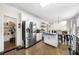 Bright kitchen with white cabinets, stainless steel appliances, a walk-in pantry and a center island at 209 Braemar Ct, Mcdonough, GA 30253