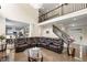 Spacious two-story living room with marble floors, a dark leather couch, and a view to the kitchen at 209 Braemar Ct, Mcdonough, GA 30253