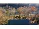 A high aerial shot of a lush, wooded property with water views at 3212 Woodhaven Sw Ct, Conyers, GA 30094