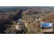 An aerial view featuring home nestled amongst lush forest and riverfront at 3212 Woodhaven Sw Ct, Conyers, GA 30094