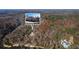 An aerial view featuring home nestled amongst lush forest and riverfront at 3212 Woodhaven Sw Ct, Conyers, GA 30094
