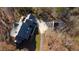 Aerial view of property with a long driveway, lush trees, and extensive surrounding grounds at 3212 Woodhaven Sw Ct, Conyers, GA 30094