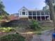 Multi-story home featuring multiple decks and a stone retaining wall in the backyard at 3212 Woodhaven Sw Ct, Conyers, GA 30094