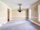 Elegant dining room with a decorative chandelier, neutral walls, and ample natural light at 3212 Woodhaven Sw Ct, Conyers, GA 30094